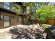 Private backyard outdoor area with brick facade, stone patio, metal stairs, and seating area at 70 N Grant St # 10, Denver, CO 80203