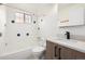 The bathroom showcases white tiles with striking blue accents, a modern vanity, and a shower-tub combination at 70 N Grant St # 10, Denver, CO 80203
