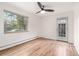 Bedroom featuring hardwood floors, bright window, and access to the outside at 70 N Grant St # 10, Denver, CO 80203