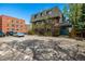 Apartment building with visible parking and landscaping on a sunny day at 70 N Grant St # 10, Denver, CO 80203