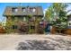 Multi-story brick building with mature trees, ample parking, and inviting entryway at 70 N Grant St # 10, Denver, CO 80203