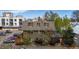 Exterior of a multi-story brick apartment building with dormer windows and lush landscaping at 70 N Grant St # 10, Denver, CO 80203