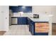 Stylish kitchen featuring navy cabinetry, stainless steel appliances, and white subway tile backsplash at 70 N Grant St # 10, Denver, CO 80203