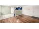 Spacious living area with hardwood and tile floors leading to a stylish, blue kitchen at 70 N Grant St # 10, Denver, CO 80203