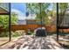 Ground level stone patio with a BBQ and dining furniture below balconies at 70 N Grant St # 10, Denver, CO 80203