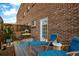 Relaxing outdoor patio featuring comfortable lounge chairs and table set against a brick wall backdrop at 70 N Grant St # 10, Denver, CO 80203