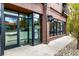 Exterior of AJ's Pit Bar-B-Q featuring glass-encased entryway and signage against a brick facade at 70 N Grant St # 10, Denver, CO 80203