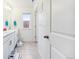 Bright bathroom with double vanity, window, and tile flooring, designed with white cabinets and a clean aesthetic at 14696 Bonsmara Dr, Mead, CO 80542