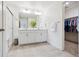 Spacious, bright bathroom with double vanity, glass shower, and walk-in closet, providing ample storage space at 14696 Bonsmara Dr, Mead, CO 80542