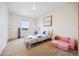 Comfortable bedroom with a plush couch, window views, and cozy carpet, perfect for relaxation and play at 14696 Bonsmara Dr, Mead, CO 80542