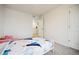 Bright bedroom with carpeted floors and a doorway leading to another room, designed with a bed and neutral palette at 14696 Bonsmara Dr, Mead, CO 80542