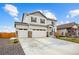 Inviting two-story home with three-car garage and stone detailing on the facade at 14696 Bonsmara Dr, Mead, CO 80542