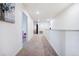 Bright hallway with white walls and neutral carpet, leading to bedrooms and living spaces at 14696 Bonsmara Dr, Mead, CO 80542