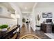 Bright hallway featuring wood floors and elegant furnishings, with a glimpse into other rooms at 14696 Bonsmara Dr, Mead, CO 80542