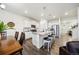Modern kitchen with stainless steel appliances, white cabinetry, and a large island with seating at 14696 Bonsmara Dr, Mead, CO 80542