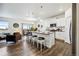 Bright, open-concept kitchen with stainless steel appliances, a center island, and seamless flow to the dining area at 14696 Bonsmara Dr, Mead, CO 80542
