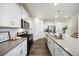 Modern kitchen features stainless steel appliances, a center island, and stylish gray countertops at 14696 Bonsmara Dr, Mead, CO 80542