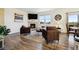 Bright and airy living room boasts a fireplace, TV, and comfortable seating overlooking a view at 14696 Bonsmara Dr, Mead, CO 80542