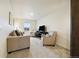 Cozy living room featuring neutral-toned furniture, window views, and a television set for entertainment at 14696 Bonsmara Dr, Mead, CO 80542