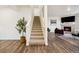 Carpeted staircase leading to the upper level of the home with lots of light and views at 14696 Bonsmara Dr, Mead, CO 80542