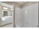 Bright bathroom with white tile, shower/bath combo, and modern vanity at 18358 Field Mint Pt, Parker, CO 80134