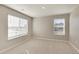 Bright bedroom boasts two large windows, neutral walls, and comfortable carpeting, filled with natural light at 18358 Field Mint Pt, Parker, CO 80134