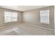 Bright bedroom boasts two large windows, neutral walls, and comfortable carpeting, filled with natural light at 18358 Field Mint Pt, Parker, CO 80134