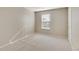Comfortable bedroom featuring neutral walls, plush carpeting, and a well-lit window space at 18358 Field Mint Pt, Parker, CO 80134