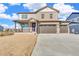 Charming two-story home with a spacious three-car garage, a welcoming front porch, and professionally landscaped yard at 18358 Field Mint Pt, Parker, CO 80134