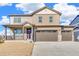 Charming two-story home with a spacious three-car garage, a welcoming front porch, and professionally landscaped yard at 18358 Field Mint Pt, Parker, CO 80134