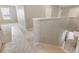 Bright hallway features neutral walls, carpeted stairs, and a glimpse of a well-lit living space at 18358 Field Mint Pt, Parker, CO 80134