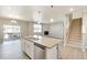 Open kitchen island with stainless dishwasher and nearby living area at 18358 Field Mint Pt, Parker, CO 80134