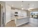 Open kitchen with island and stainless steel appliances near deck at 18358 Field Mint Pt, Parker, CO 80134