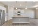 Stylish kitchen with island, pendant lights, and stainless appliances at 18358 Field Mint Pt, Parker, CO 80134