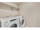 Bright laundry room featuring shelving and modern appliances, providing convenience and ample storage at 18358 Field Mint Pt, Parker, CO 80134