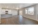 Bright open-concept living area with modern fireplace and vinyl flooring, seamlessly connects to the kitchen at 18358 Field Mint Pt, Parker, CO 80134