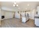 Bright open-concept living area with modern fireplace and vinyl flooring, seamlessly connects to the kitchen at 18358 Field Mint Pt, Parker, CO 80134