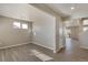 Bright living room with gray vinyl flooring, large windows, and neutral paint at 18358 Field Mint Pt, Parker, CO 80134