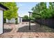 Spacious backyard featuring a brick patio, gravel, landscaping and detached garage at 1264 Uinta St, Denver, CO 80220
