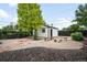 Spacious backyard featuring a brick patio, gravel, landscaping and detached garage at 1264 Uinta St, Denver, CO 80220
