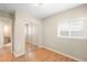 Bright bedroom featuring hardwood floors, closet with mirrored doors, and a window allowing ample natural light at 1264 Uinta St, Denver, CO 80220