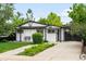 Charming home with a swing and nicely landscaped front yard and walkway at 1264 Uinta St, Denver, CO 80220