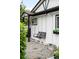 Close-up view of a charming white home's porch swing and a black framed window with flowers at 1264 Uinta St, Denver, CO 80220