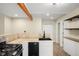 Bright kitchen featuring stainless steel appliances, stone countertops, and shelving at 1264 Uinta St, Denver, CO 80220