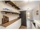 Open kitchen featuring custom shelving, wood countertops, and modern appliances at 1264 Uinta St, Denver, CO 80220