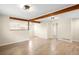 Spacious living room featuring beautiful flooring, modern lighting, and exposed wood beams at 1264 Uinta St, Denver, CO 80220