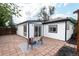 Cozy patio area with brick pavers, outdoor seating, and stylish black and white rug at 1264 Uinta St, Denver, CO 80220