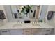 Stylish bathroom featuring a double vanity with marble countertop and modern fixtures at 1295 Utica St, Denver, CO 80204