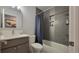 Updated bathroom featuring a sink and tub, with gray subway tiles and modern fixtures at 1295 Utica St, Denver, CO 80204