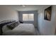 Neutral bedroom with a window and sliding closet doors offers a calm and inviting space at 1295 Utica St, Denver, CO 80204